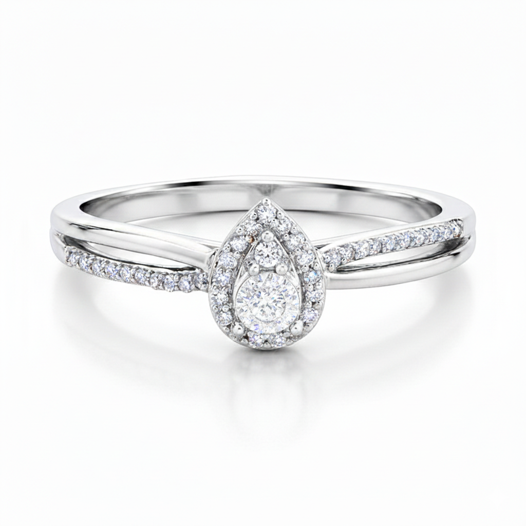 This Sterling Silver promise ring, with a 1/10 total carat weight, features a beautiful pear-shaped cluster of round diamonds, surrounded by a stunning halo for a sparkling and elegant look.