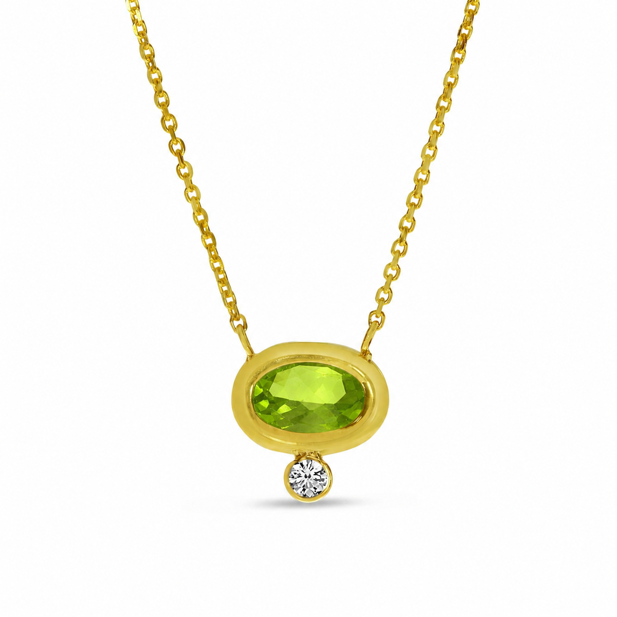 A vivid 6x4mm oval peridot shines from within a smooth high-polish bezel, accented by a delicate round diamond drop totaling .017 carat. Set in 14K yellow gold and suspended from a refined chain, this pendant brings a fresh pop of color to an effortlessly elegant design.