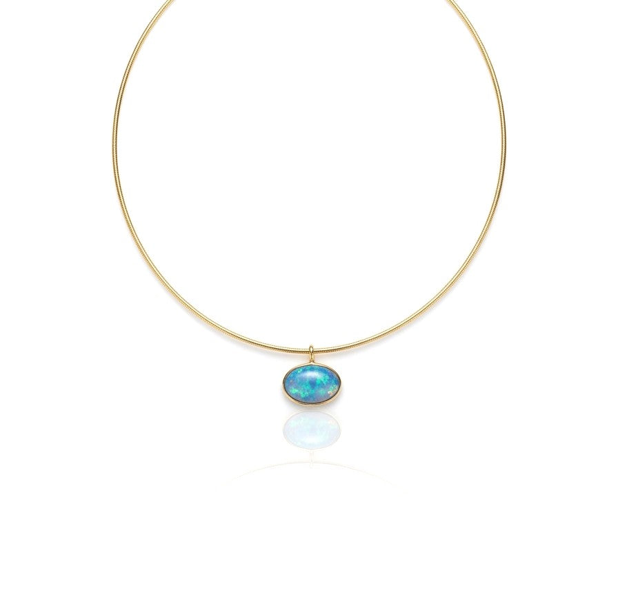 A luminous 16 x 11mm oval opal is elegantly bezel set in 14K yellow gold, revealing captivating flashes of blue and green inspired by the crystal-clear waters of the Caribbean. Suspended from a sleek necklace, this timeless pendant brings vibrant color and effortless sophistication to any jewelry collection.