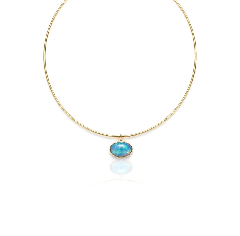 A luminous 16 x 11mm oval opal is elegantly bezel set in 14K yellow gold, revealing captivating flashes of blue and green inspired by the crystal-clear waters of the Caribbean. Suspended from a sleek necklace, this timeless pendant brings vibrant color and effortless sophistication to any jewelry collection.
