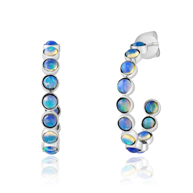 Luminous opals are bezel set in polished 14K white gold, creating a graceful hoop with brilliant flashes of blue and green from every angle. These contemporary earrings showcase the mesmerizing beauty of opal in a sleek, modern silhouette that's perfect for everyday wear or special occasions.