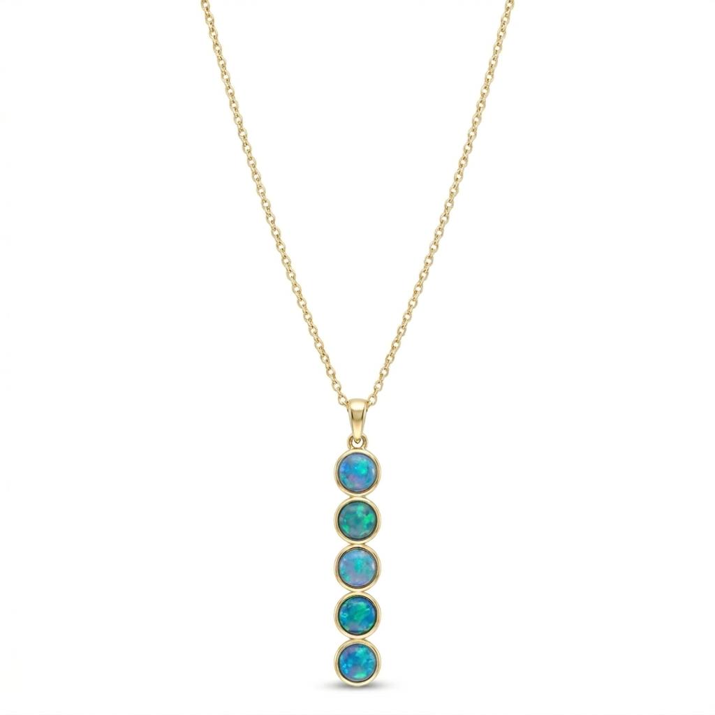 Five vibrant 4mm round opals are bezel set in polished 14K yellow gold, creating a graceful drop of brilliant blue and green flashes. Suspended from a classic cable chain, this elegant pendant captures the luminous beauty of Caribbean waters in a sleek, contemporary design.