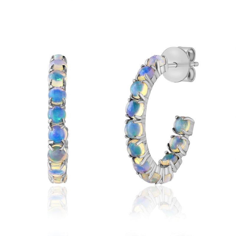 Twenty-four 3mm round opals are prong set in polished 14K white gold, creating elegant hoops filled with captivating flashes of blue and green. Their timeless silhouette and vibrant play of color make these earrings a beautiful choice for everyday wear or special occasions.