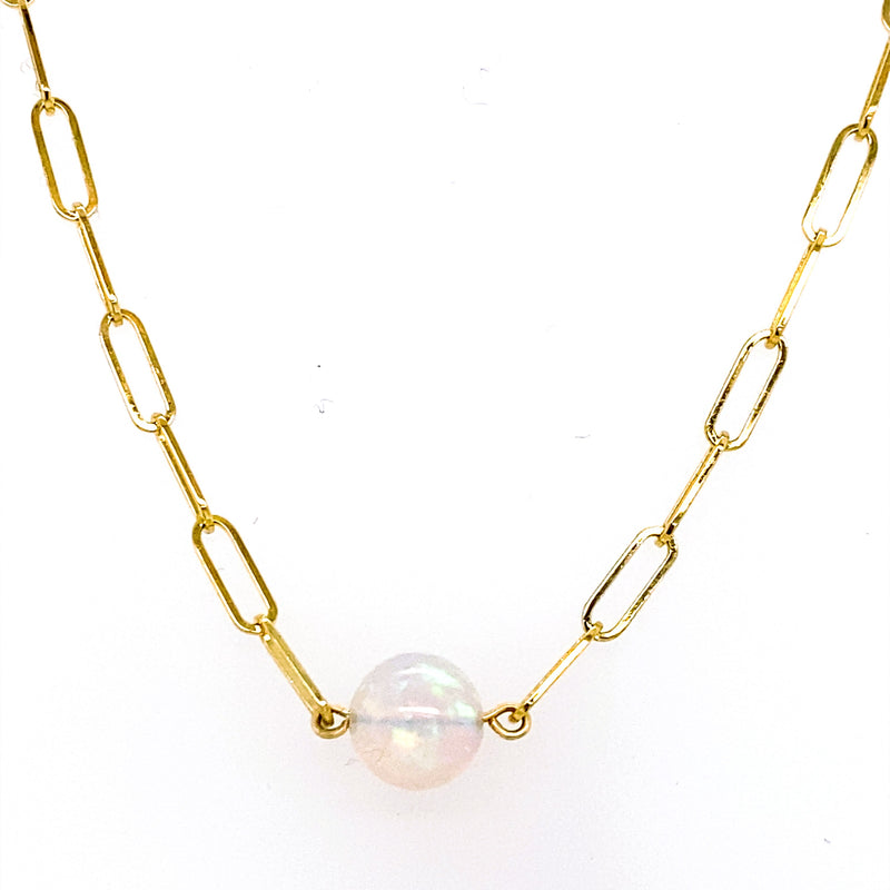 A luminous opal bead is suspended between polished 14K yellow gold paperclip links, creating a clean, contemporary design with subtle iridescence. Finished with an 18-inch paperclip chain, this modern necklace offers effortless style with a fresh take on classic opal jewelry.