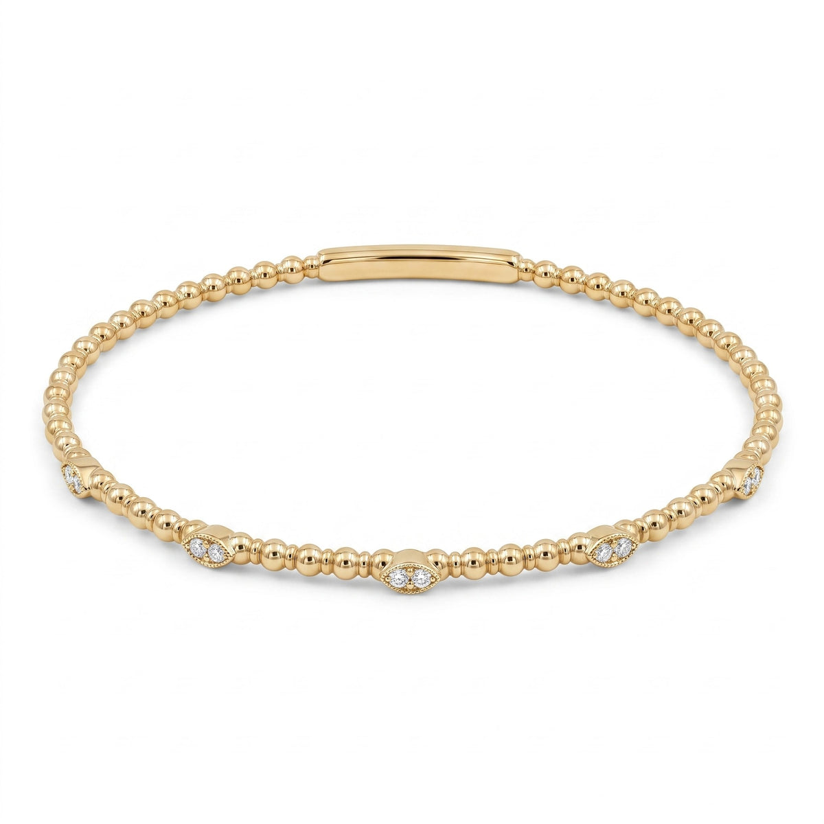 A delicate yellow gold beaded bracelet with a polished bar clasp and small diamond accents spaced along the front, displayed on a clean white background.