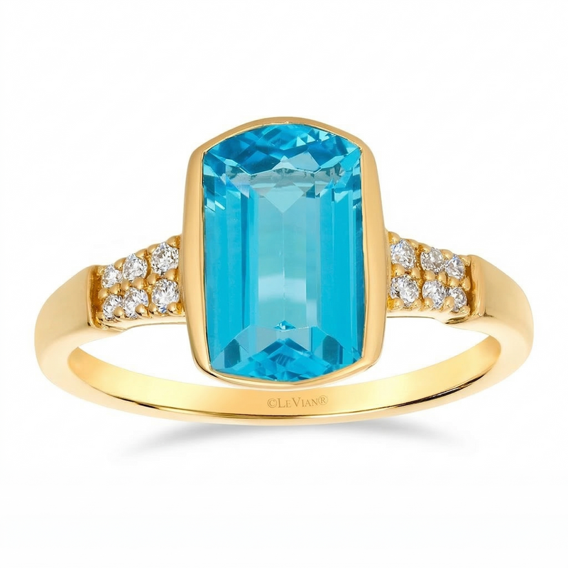 A vivid 2.379 carat ocean blue topaz takes center stage in this 14K honey gold ring, framed by a smooth bezel that enhances its rich color and depth. Diamond accents shimmer along the shoulders, totaling .08 carat weight, adding a soft, radiant sparkle to this bold yet refined design.