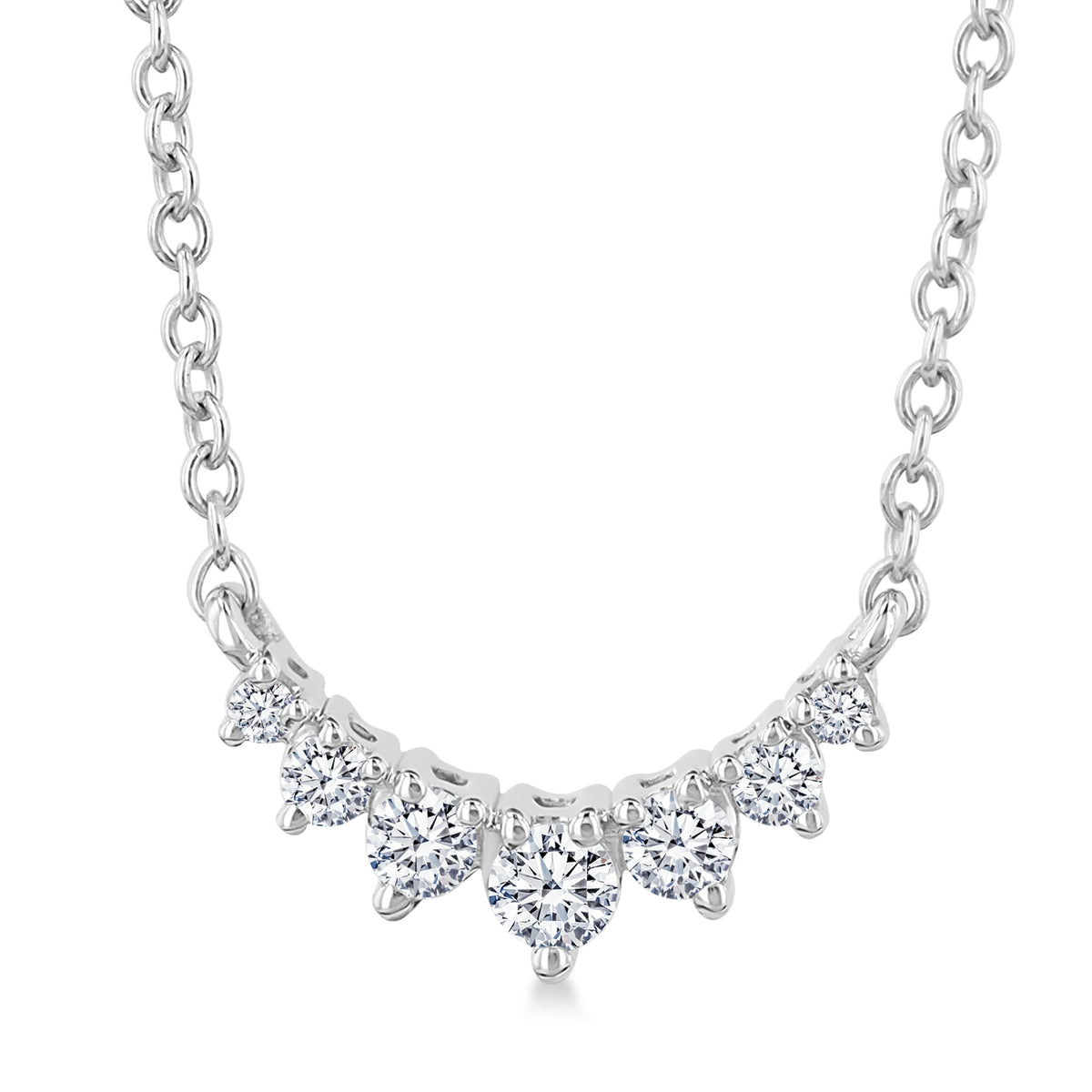 Indulge with this 10K white gold necklace, showcasing a graceful swooping smile design adorned with graduated all-round diamonds.