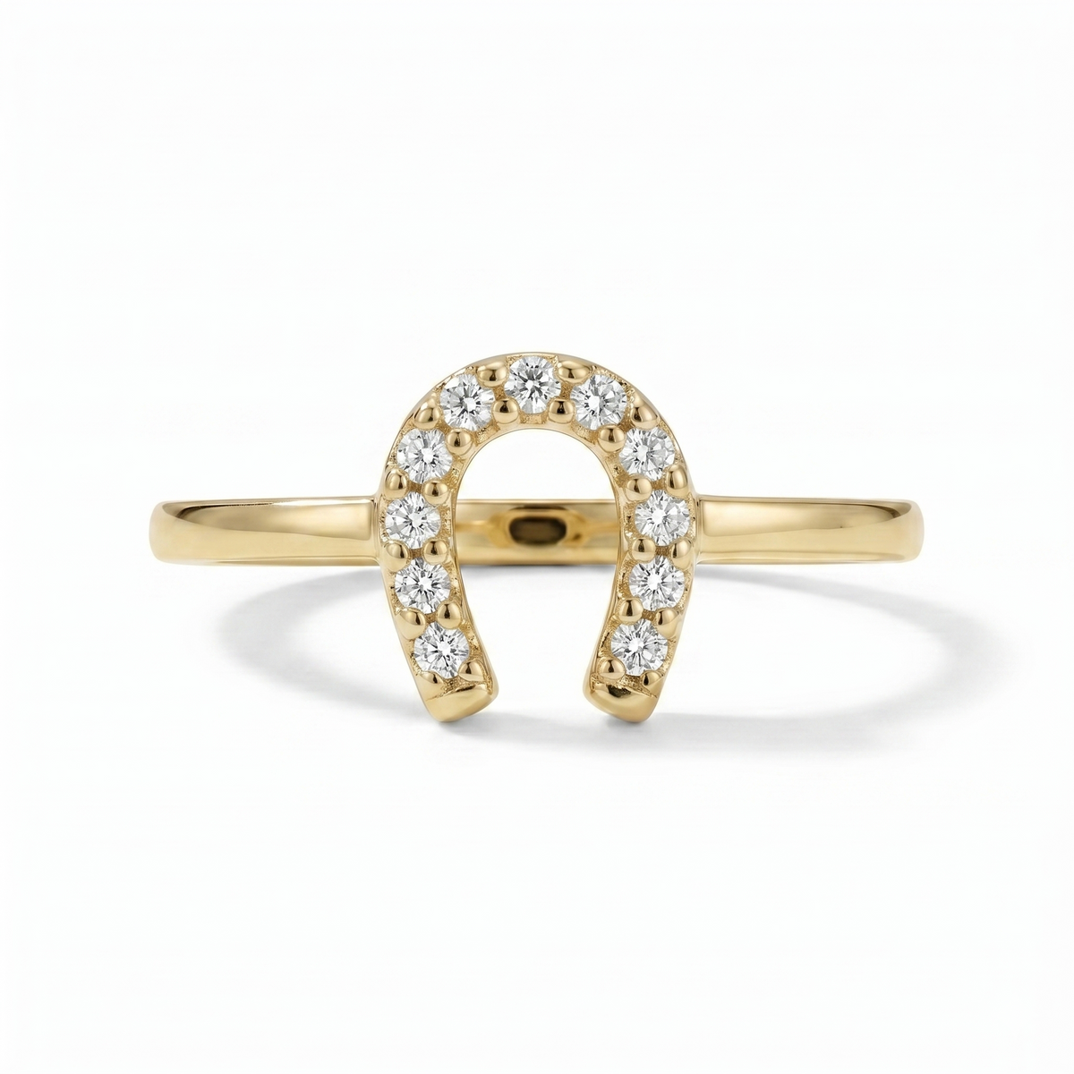 A classic horseshoe silhouette is traced with shimmering diamonds, creating a symbol of luck with a refined golden glow. Crafted in 10K yellow gold with 1/10 carat total weight of diamonds, this ring brings a touch of sparkle and everyday charm to a meaningful design.