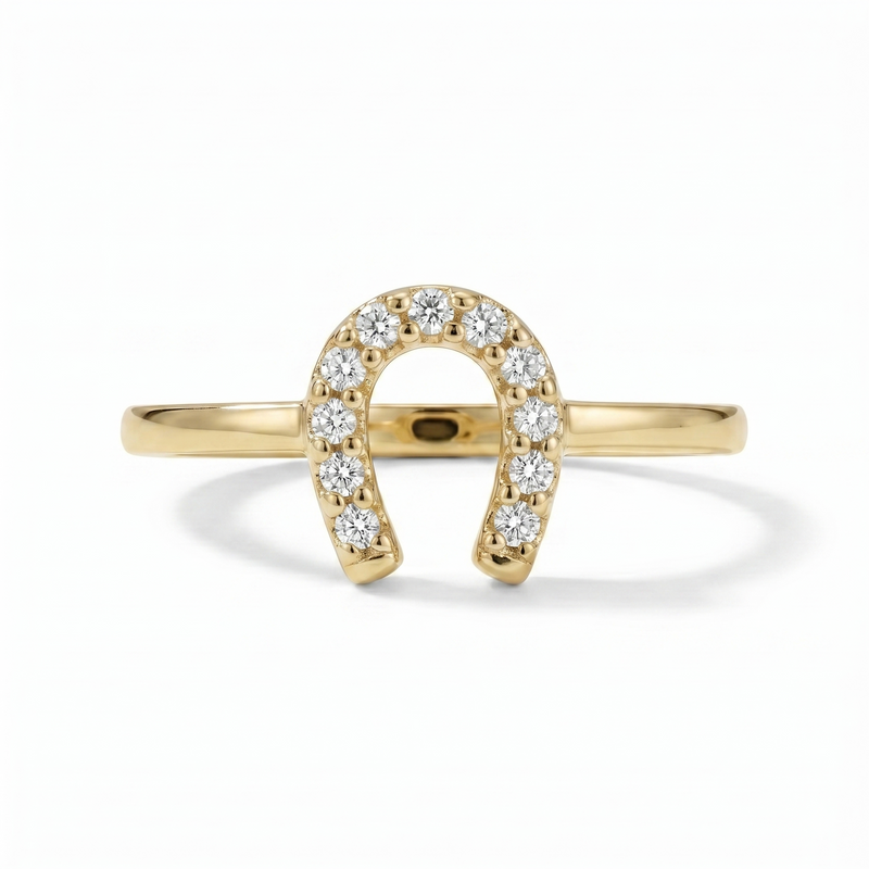 A classic horseshoe silhouette is traced with shimmering diamonds, creating a symbol of luck with a refined golden glow. Crafted in 10K yellow gold with 1/10 carat total weight of diamonds, this ring brings a touch of sparkle and everyday charm to a meaningful design.