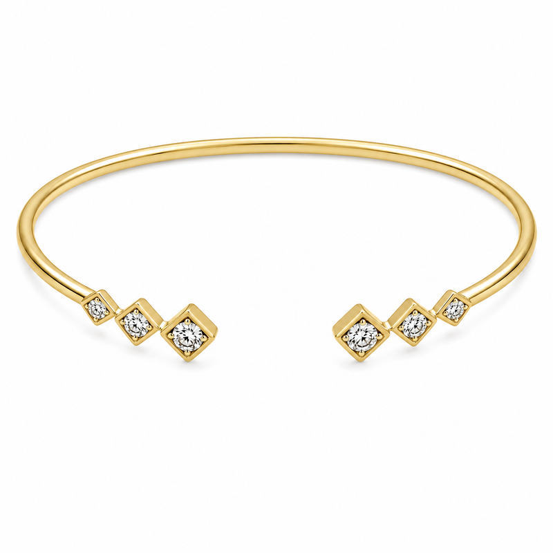 Round diamonds totaling 1/7 carat are framed in graduated square settings along the open ends of this 14K yellow gold bangle. The geometric design gives the classic diamond bangle a fresh, modern look.