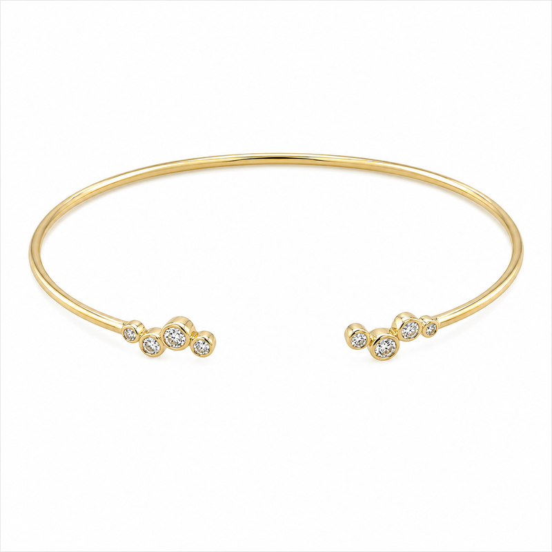 Playful clusters of bezel-set diamonds bring a fresh look to this 14K yellow gold bracelet, with 1/5 carat total weight of diamonds. The scattered bubble design gives each end a light, airy sparkle while the flexible silhouette makes it easy to wear alone or stacked.