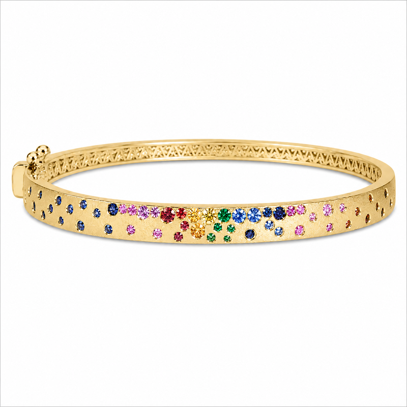 A vibrant mix of rainbow sapphires and vivid tsavorites creates a colorful cascade across this satin-finished 14K yellow gold 5mm bangle. The thoughtfully arranged gemstones bring playful energy and brilliant color to the sleek silhouette, while the hinged design offers a secure, comfortable fit.