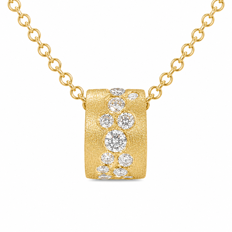 A softly textured 14K yellow gold pendant is scattered with 1/3 carat total weight of diamonds in varying sizes, creating a beautiful cascade of sparkle. An adjustable 18-inch bolo chain completes the design with a distinctive finishing touch.