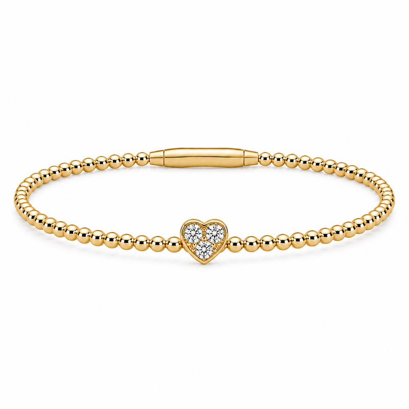 A sparkling diamond heart rests at the center of this elegant 14K yellow gold Flexie bracelet, blending delicate romance with modern simplicity. Featuring 1/6 carat total weight of diamonds, the polished beaded design offers flexible comfort and a graceful everyday shimmer.
