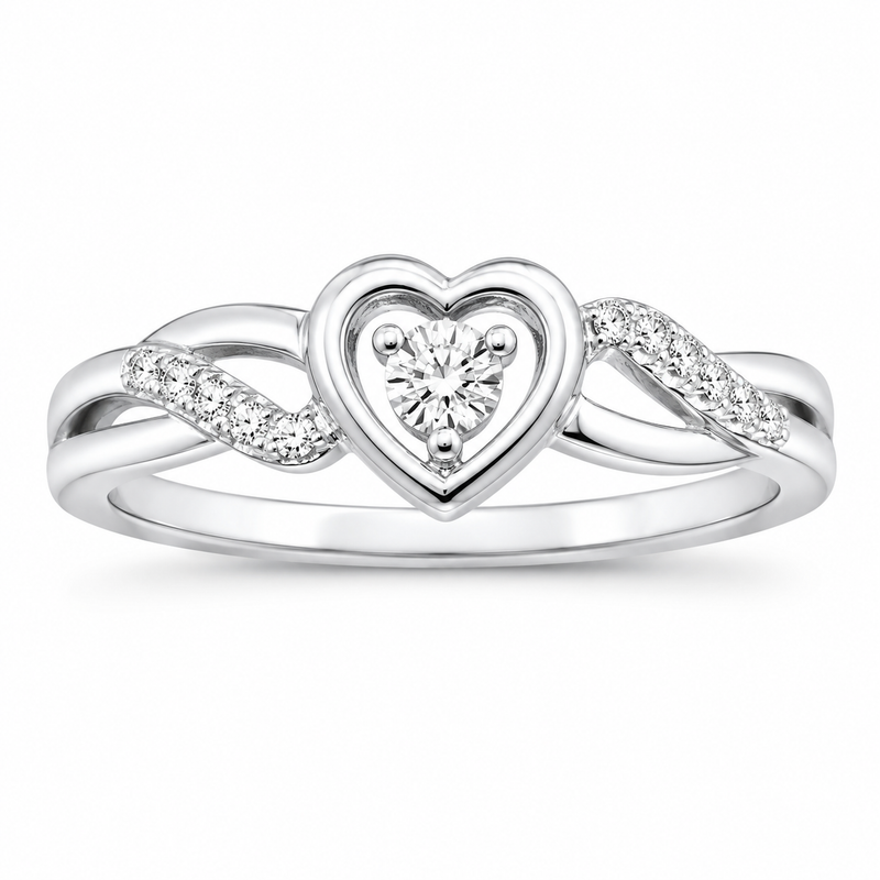 A silver heart-shaped ring with a central heart-shaped diamond and small diamonds along the band, shown on a plain white background.