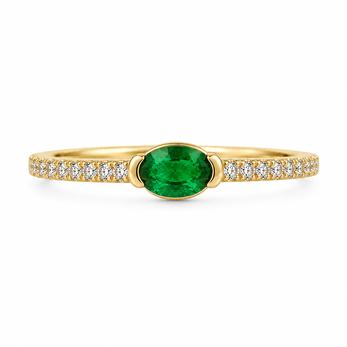 A modern spin on a classic design, this chic ring showcases a vibrant genuine oval emerald set horizontally in a sleek half-bezel East-West setting. Crafted in warm 14K yellow gold and framed by a sparkling diamond-accented band, it features 1/3 CTW of emerald brilliance paired with 1/6 CTW of diamonds for an unforgettable pop of green elegance.