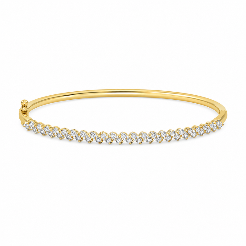Two rows of round diamonds create a layered wave pattern throughout this 14K yellow gold bangle. The diamonds total 2 2/8 carats total weight, giving the entire design incredible dimension and sparkle.